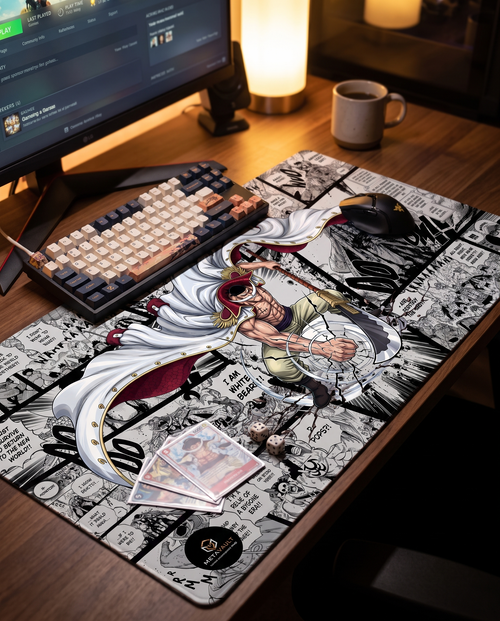 Whitebeard One Piece playmat on a gaming desk setup with keyboard and cards